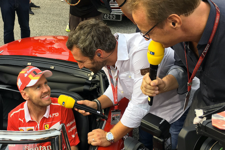 Timo Glock und Florian König von RTL mit Sebastian Vettel
