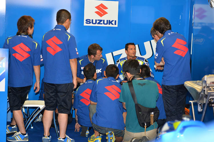 Testfahrer de Puniet informiert die Suzuki-Teammitglieder