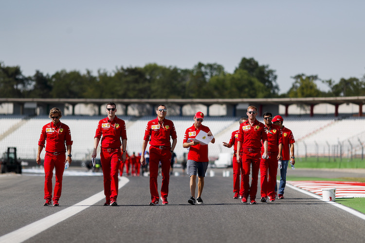 Sebastian Vettel (mit weisser Mappe) und seine Techniker beim Pistenrundgang in Hockenheim