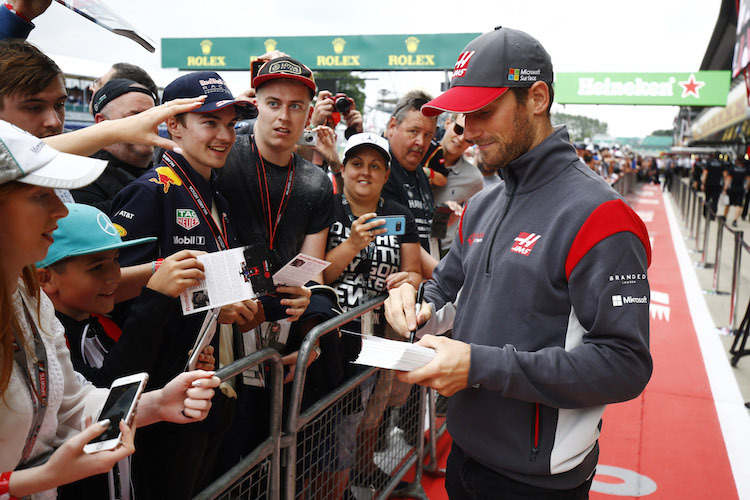 Romain Grosjean schreibt Autogramme