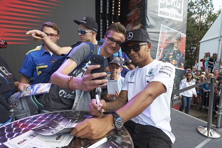 Red Bull Ring, Spielberg, Austria.
Saturday 21 June 2014.
Lewis Hamilton, Mercedes AMG, has a picture taken with a fan.
World Copyright: Steve Etherington/LAT Photographic.
ref: Digital Image SNE25434 copy