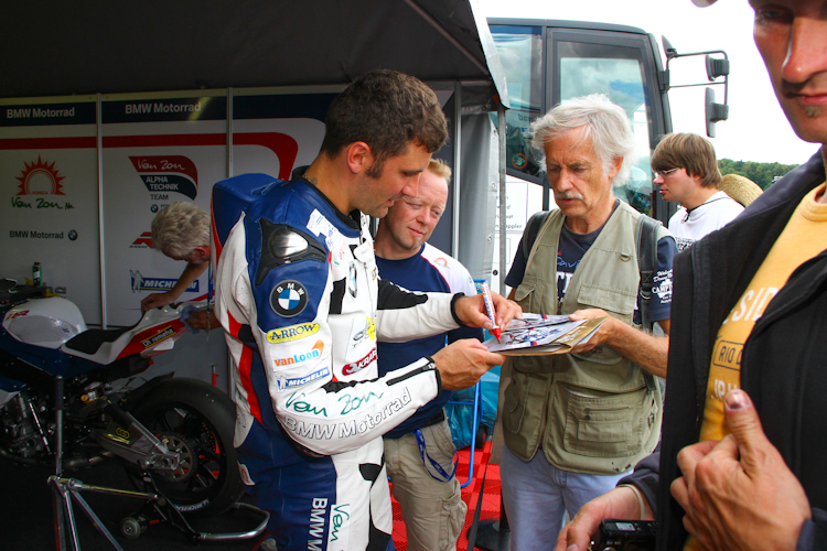 Erwan Nigon und sein Teamchef Werner Daemen geben Autogramme
